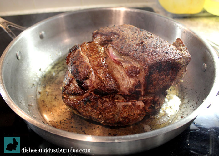 Browning the meat in the pan before slow cooking