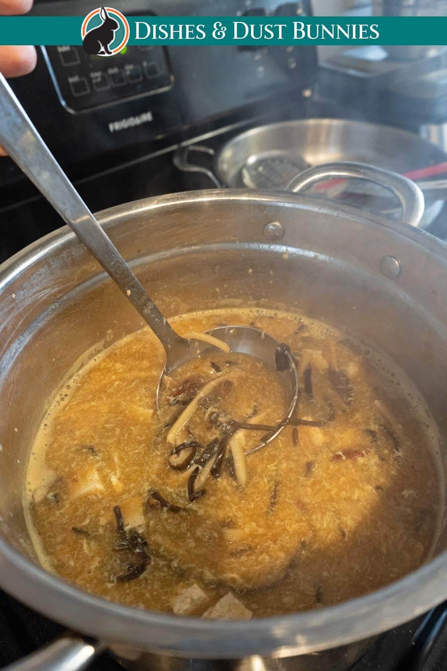 Hot and sour soup simmering after cooking the egg to for delicate egg ribbons. 